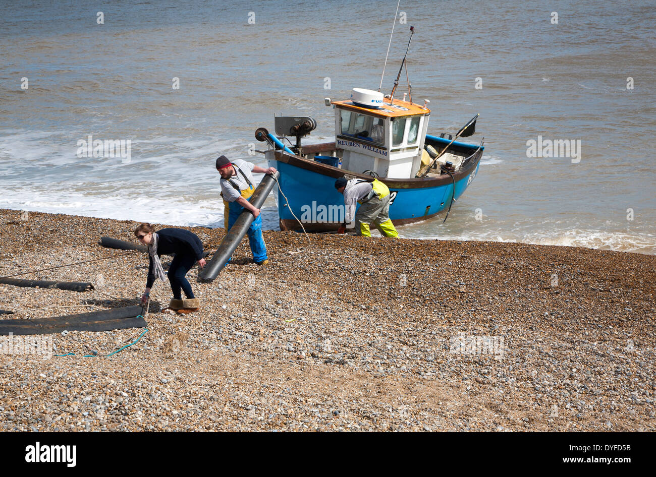 Small inshore fishing boat landing on the beach after six hours at sea with a catch of cod and skate, Aldeburgh, Suffolk, Stock Photo