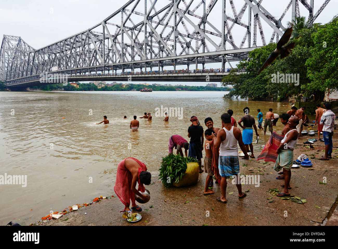 India, West Bengal, Kolkata, Calcutta, Ghat near Howrah bridge, People bathing in Hooghly River Stock Photo