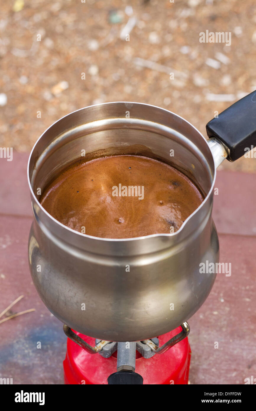 Espresso coffee in a Cuban coffee maker using a mini gas stove with a  propane tank on a single burner. A thunderstorm is brewing in the  background Stock Photo - Alamy