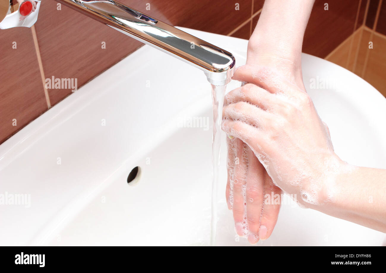 Washing of hands with soap under running water Stock Photo - Alamy