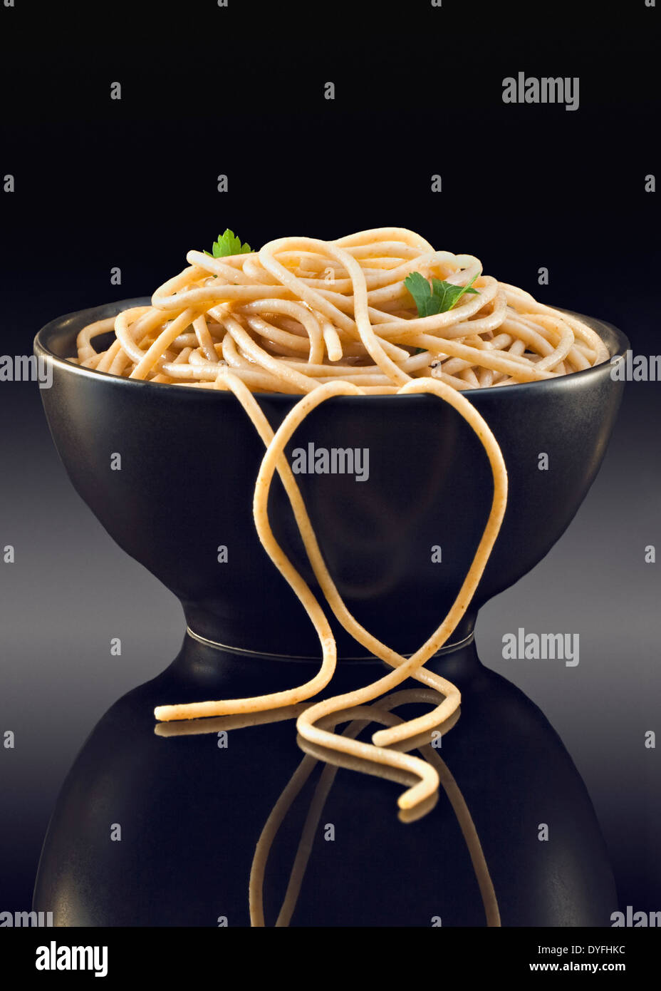 Wholemeal Spaghetti in black bowl Stock Photo Alamy