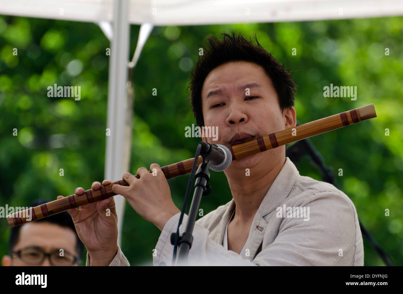 Bamboo flute player performing at the Mardi Gras, part of the Edinburgh