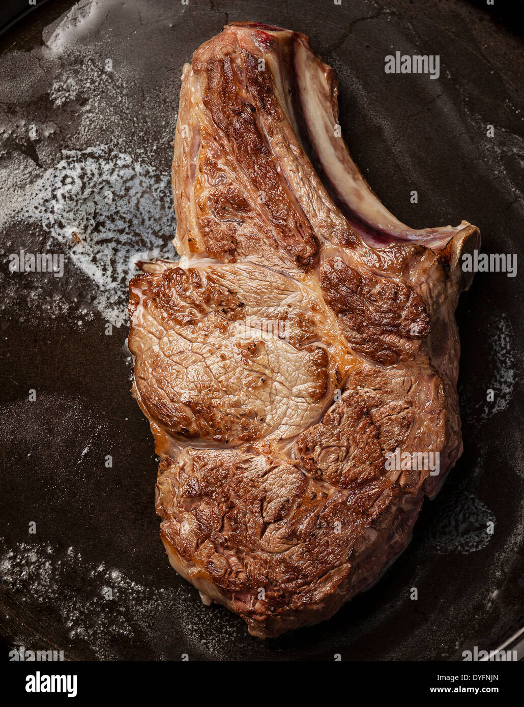 Veal cutlet with bone on pan Stock Photo
