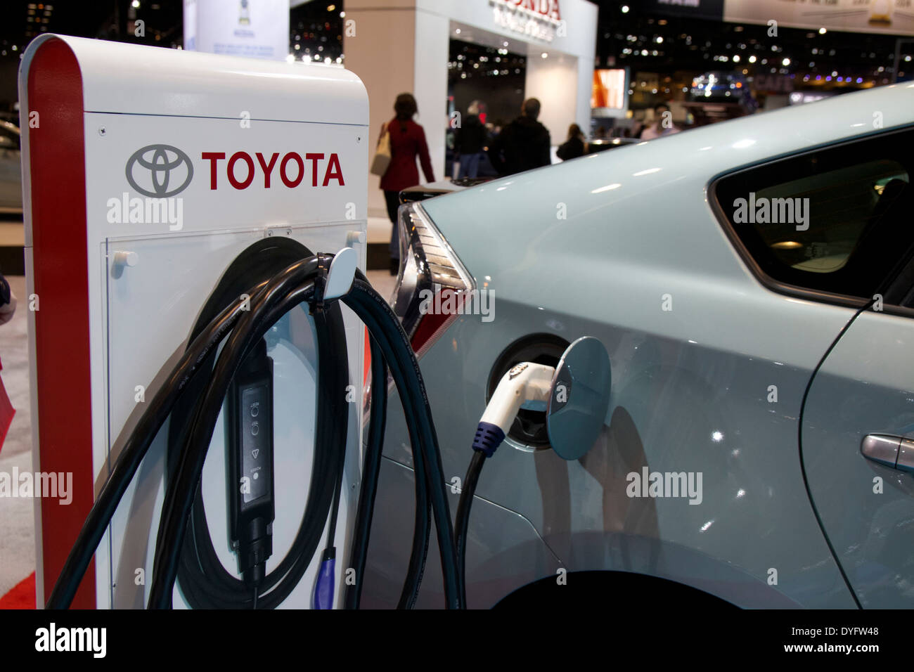 Toyota Prius plugin hybrid and charging station. 2014 Chicago Auto Show Stock Photo
