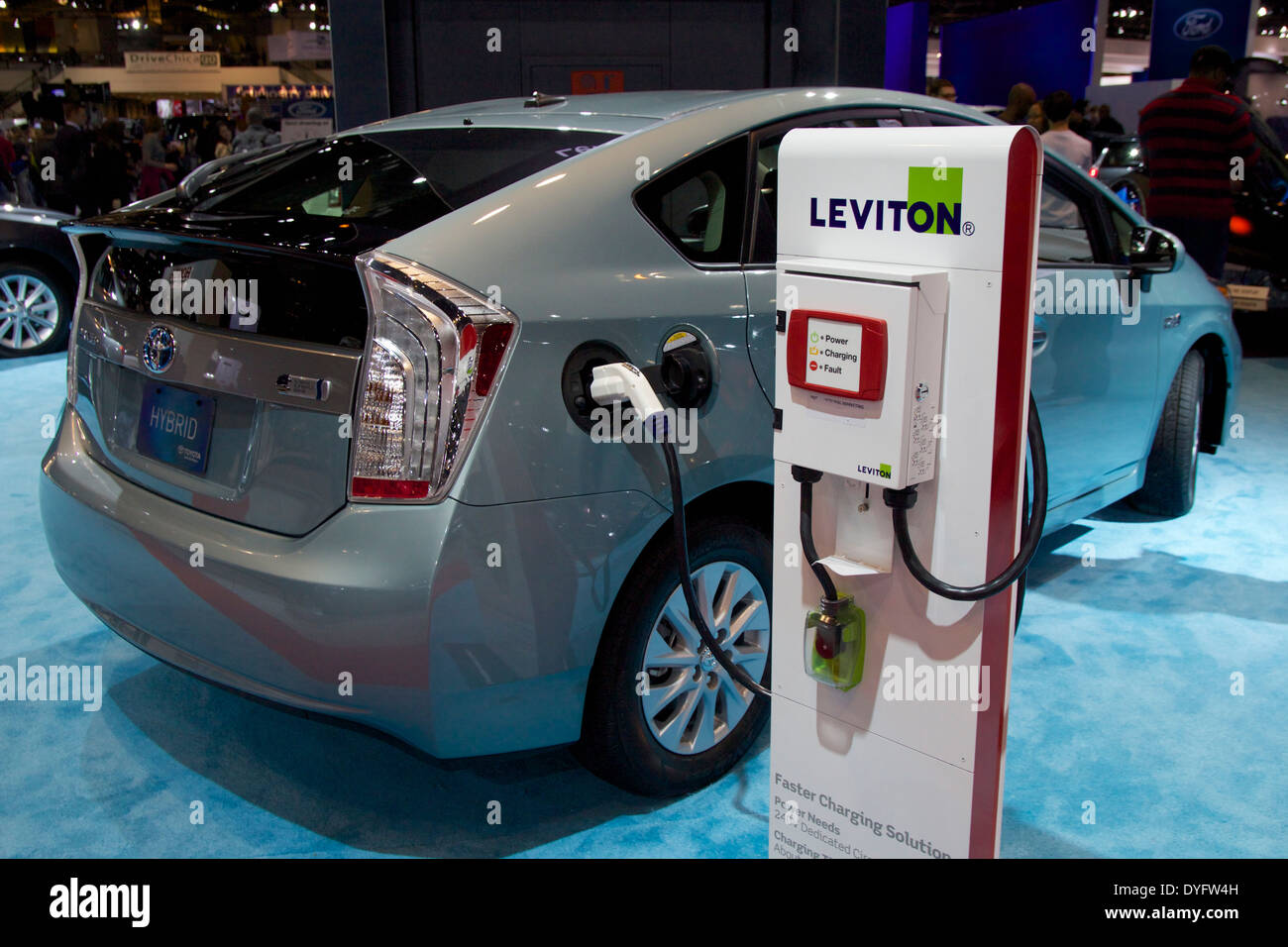 Toyota Prius plugin hybrid and charging station. 2014 Chicago Auto Show Stock Photo