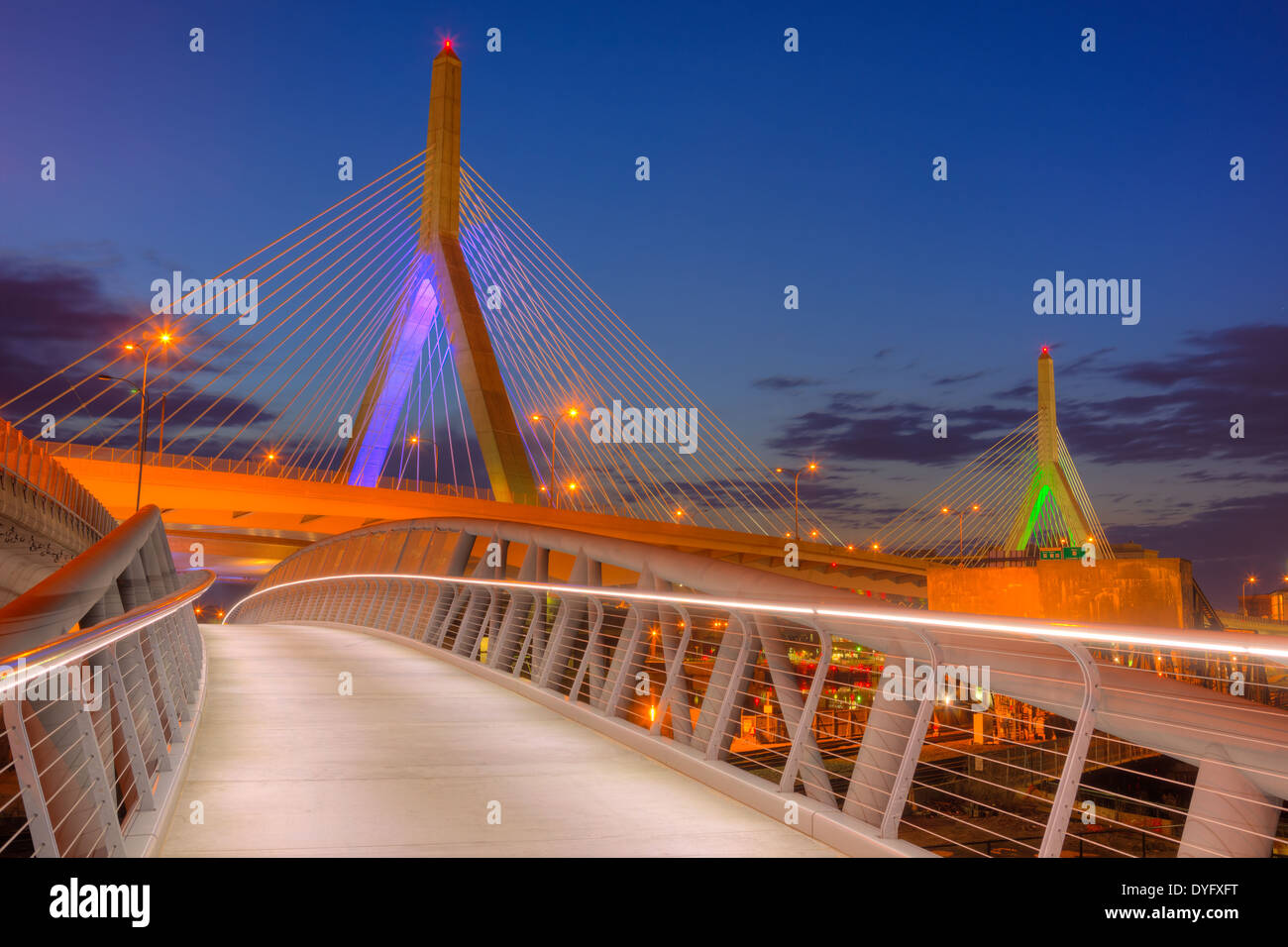 The North Bank Bridge for pedestrians and cyclists curves under the Leonard P. Zakim Bunker Hill Memorial Bridge in Boston, Mass Stock Photo