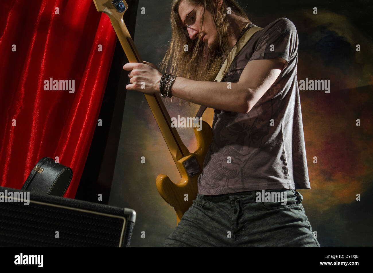 rock guitar player on stage with amp Stock Photo