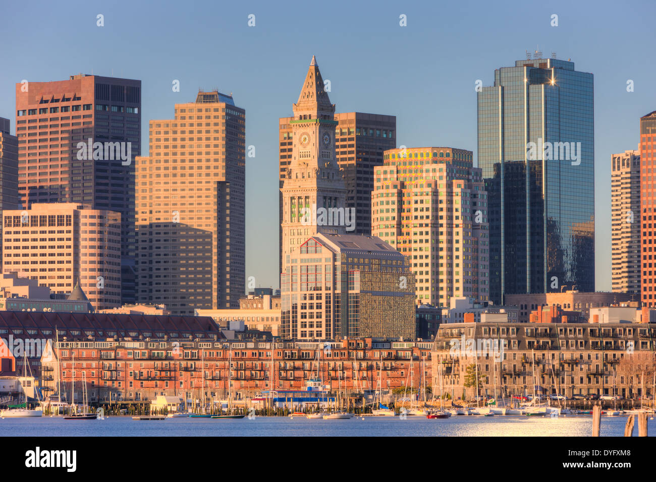 A morning view of the Custom House Tower, the Financial District, and low rise wharves on the waterfront in Boston, Massachusetts. Stock Photo