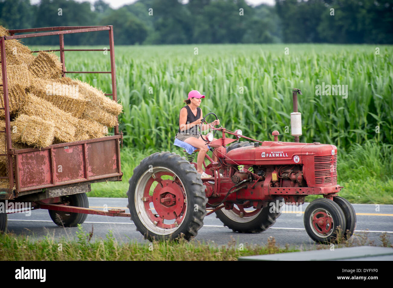 Woman farmer hauling hay wagon with tractor Stock Photo 68577684 Alamy