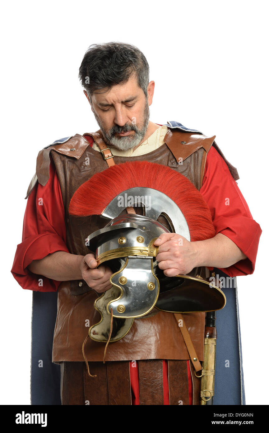 Portrait of Roman soldier praying while holding helmet Stock Photo