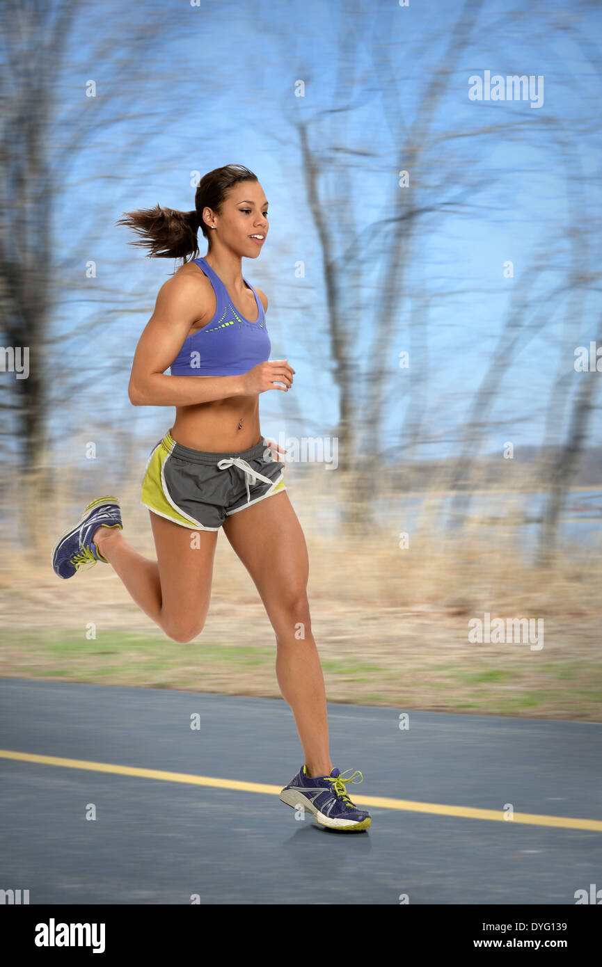 African American woman running outdoors Stock Photo