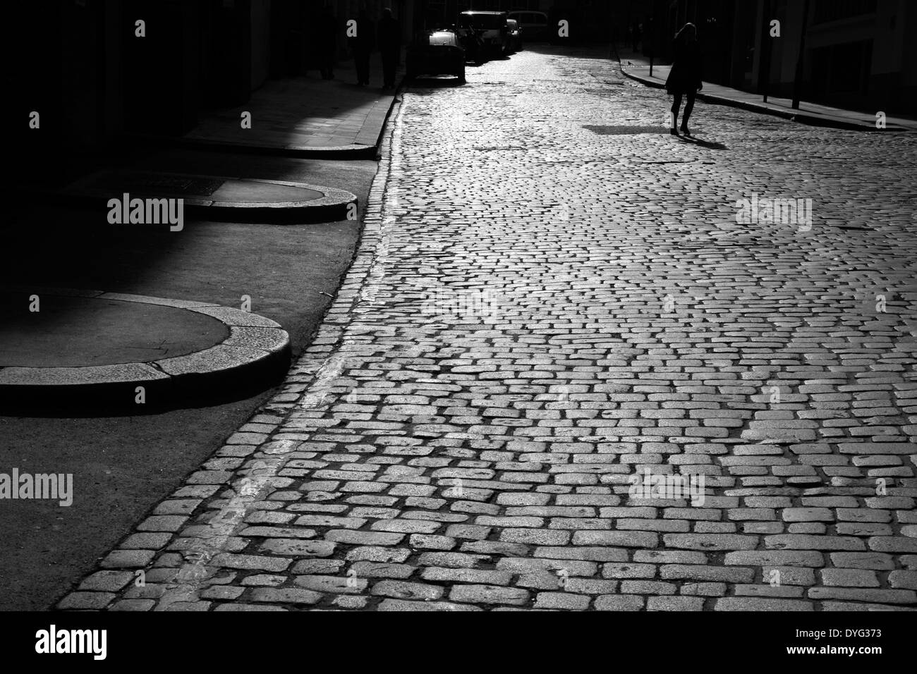 Walking across the cobbles of Back Hill, Clerkenwell, London, UK Stock Photo