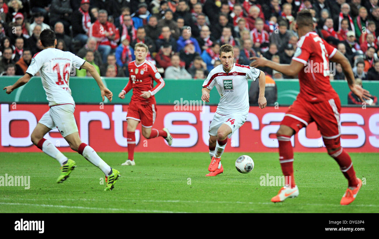 Munich, Germany. 16th Apr, 2014. Kaiserslautern's Willi Orban (2-R) and Karim Matmour storm torwards Munich's Jerome Boateng while Toni Kroos looks on from behind during the DFB Cup semifinal match between FC Bayern Munich and FC Kaiserslautern at Allianz Arena in Munich, Germany, 16 April 2014. Photo: Nicolas Armer/dpa/Alamy Live News Stock Photo
