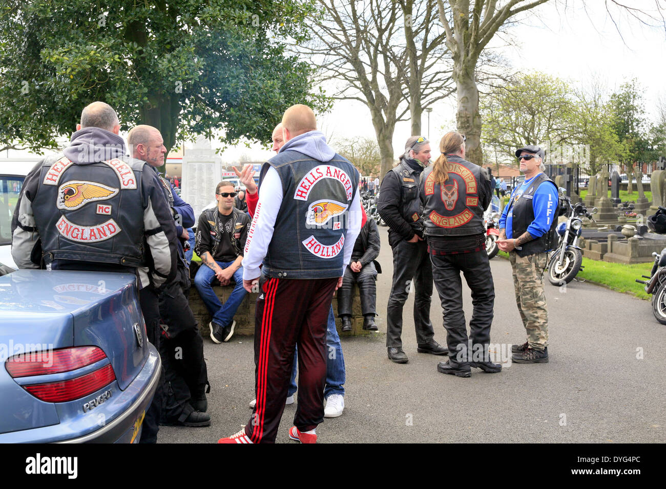 Groups of international Hells Angels in conversations at a chapter president's funeral. Stock Photo