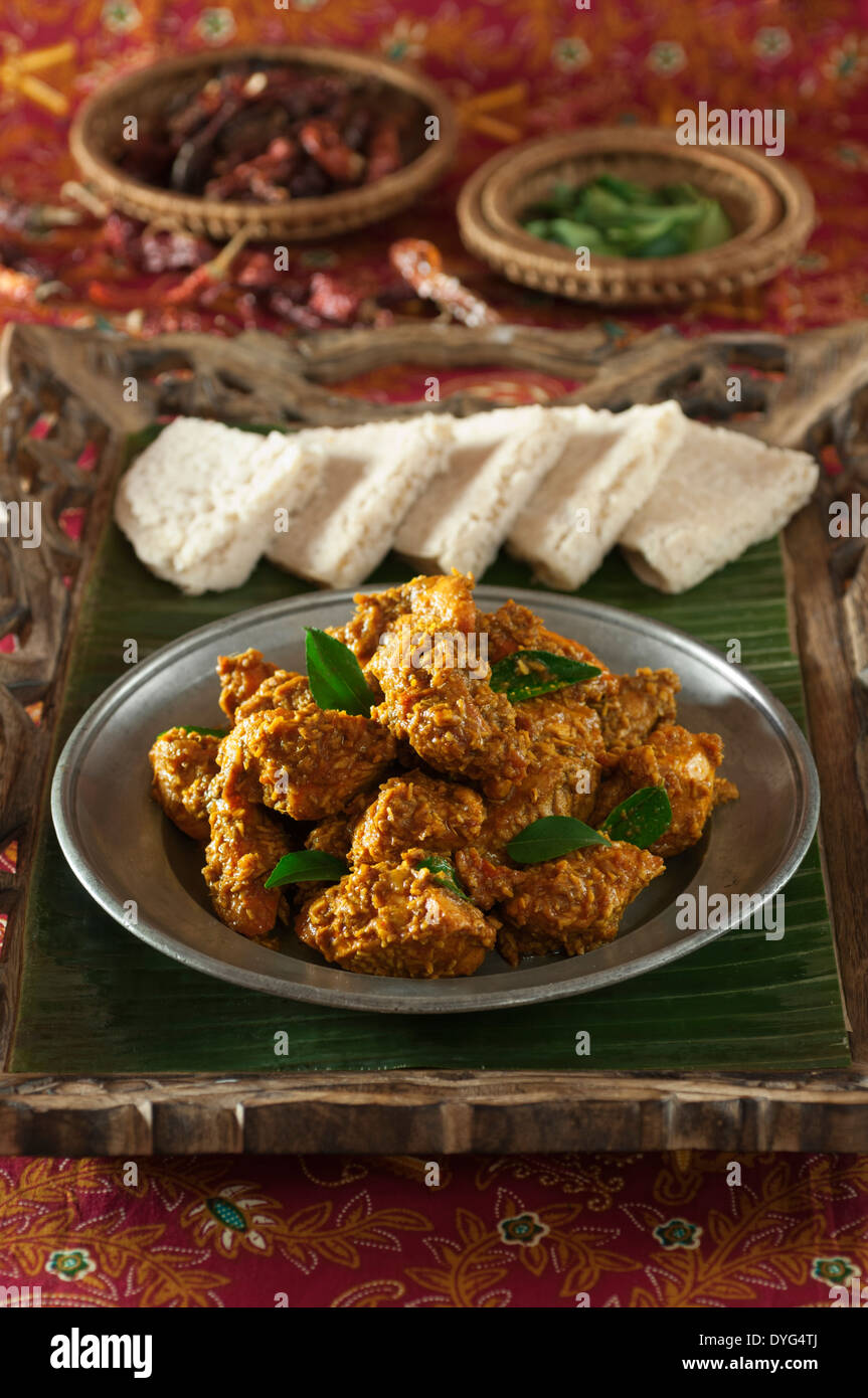 Chicken Sukka. Mangalore style dry coconut curry with neer dosas Stock Photo