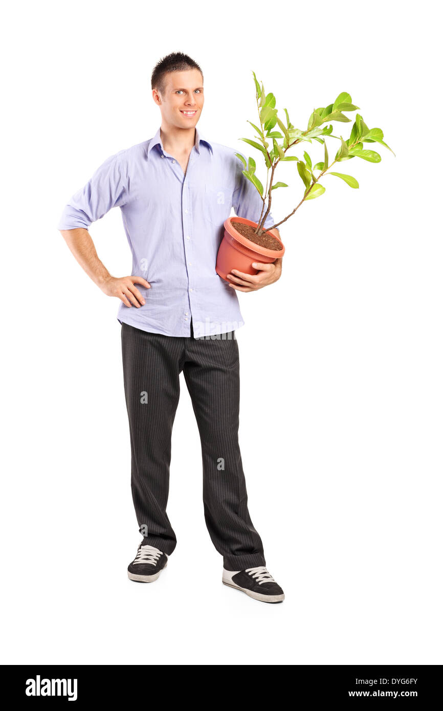 Full length portrait of a young man holding a plant Stock Photo - Alamy
