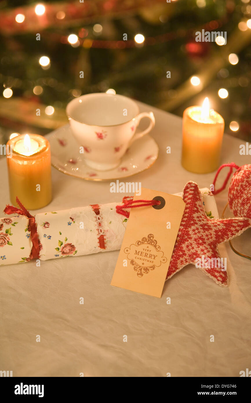 Vintage Christmas Decorations on a table top with antique,baubles,cracker,tea cup and cake stand, Stock Photo