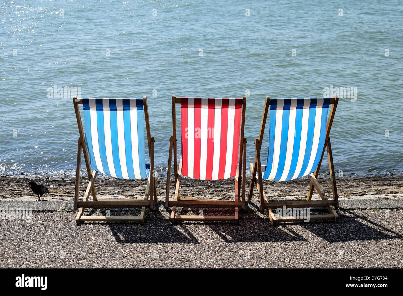 Three empty deck chairs on Southend seafront. Stock Photo