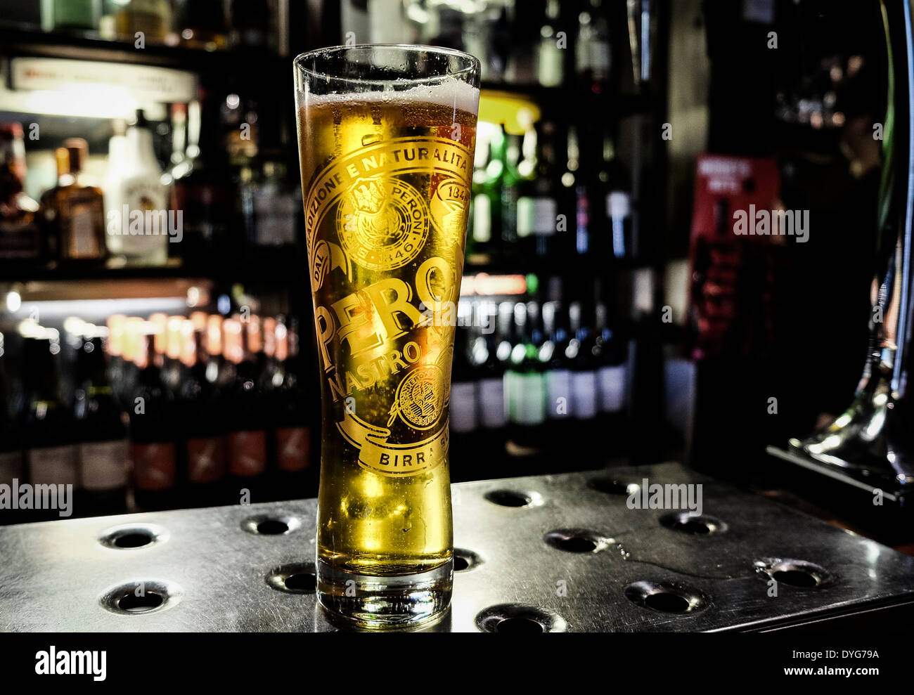 A pint glass of Peroni beer on a bar in a pub. Stock Photo