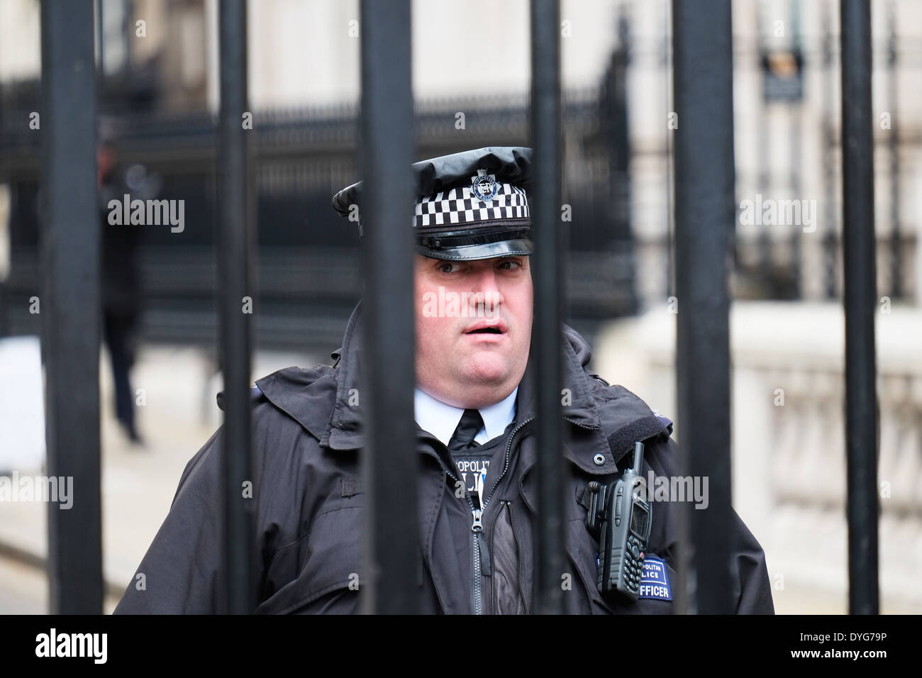 A Metropolitan Police Officer on duty behind the Gates of Downing Street in London. Stock Photo