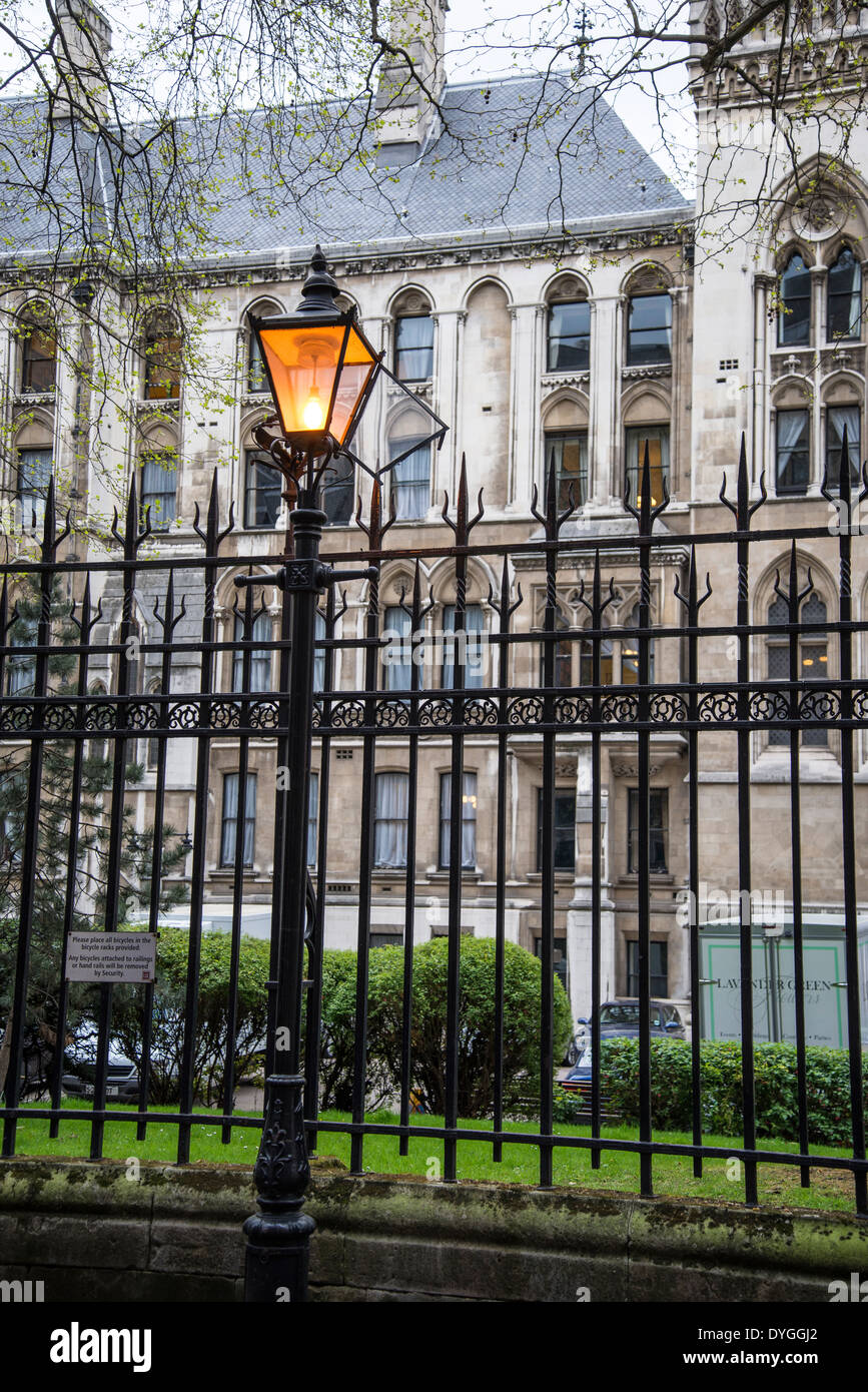 Atmospheric railings and lanterns in Clement's Inn passage, behind Royal Court of Justice, London , UK Stock Photo