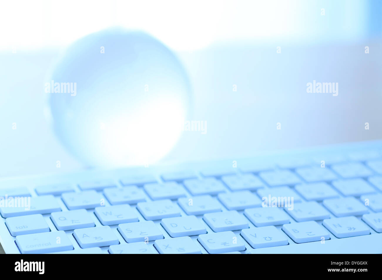 Glass globe and computer Stock Photo - Alamy