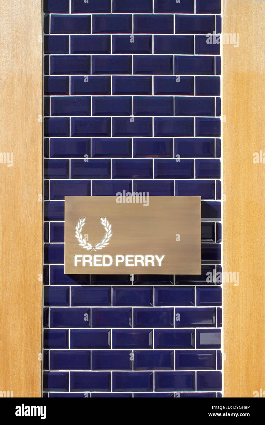 Fred Perry, München, Munich, Germany. Architect: BuckleyGrayYeoman, 2012. Signage on tiles wall. Stock Photo