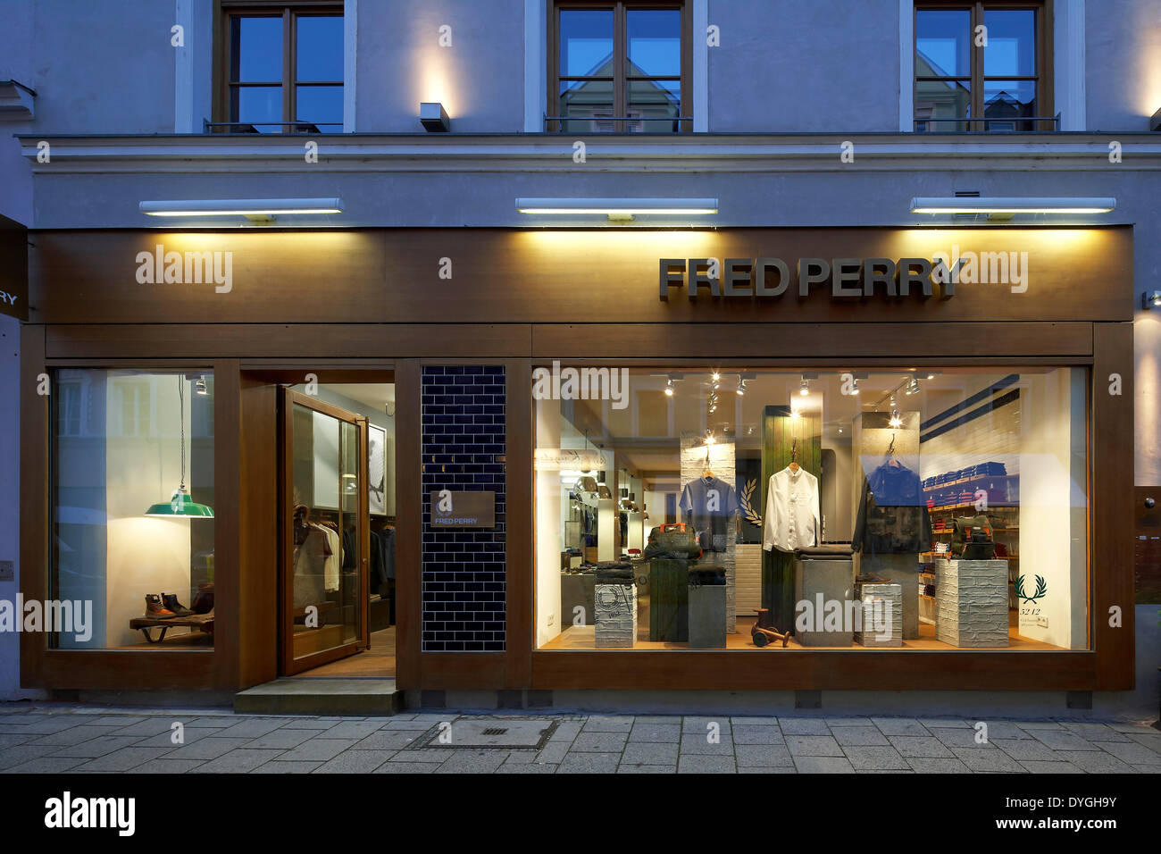 Fred Perry, München, Munich, Germany. Architect: BuckleyGrayYeoman, 2012. Exterior front elevation at dusk. Stock Photo