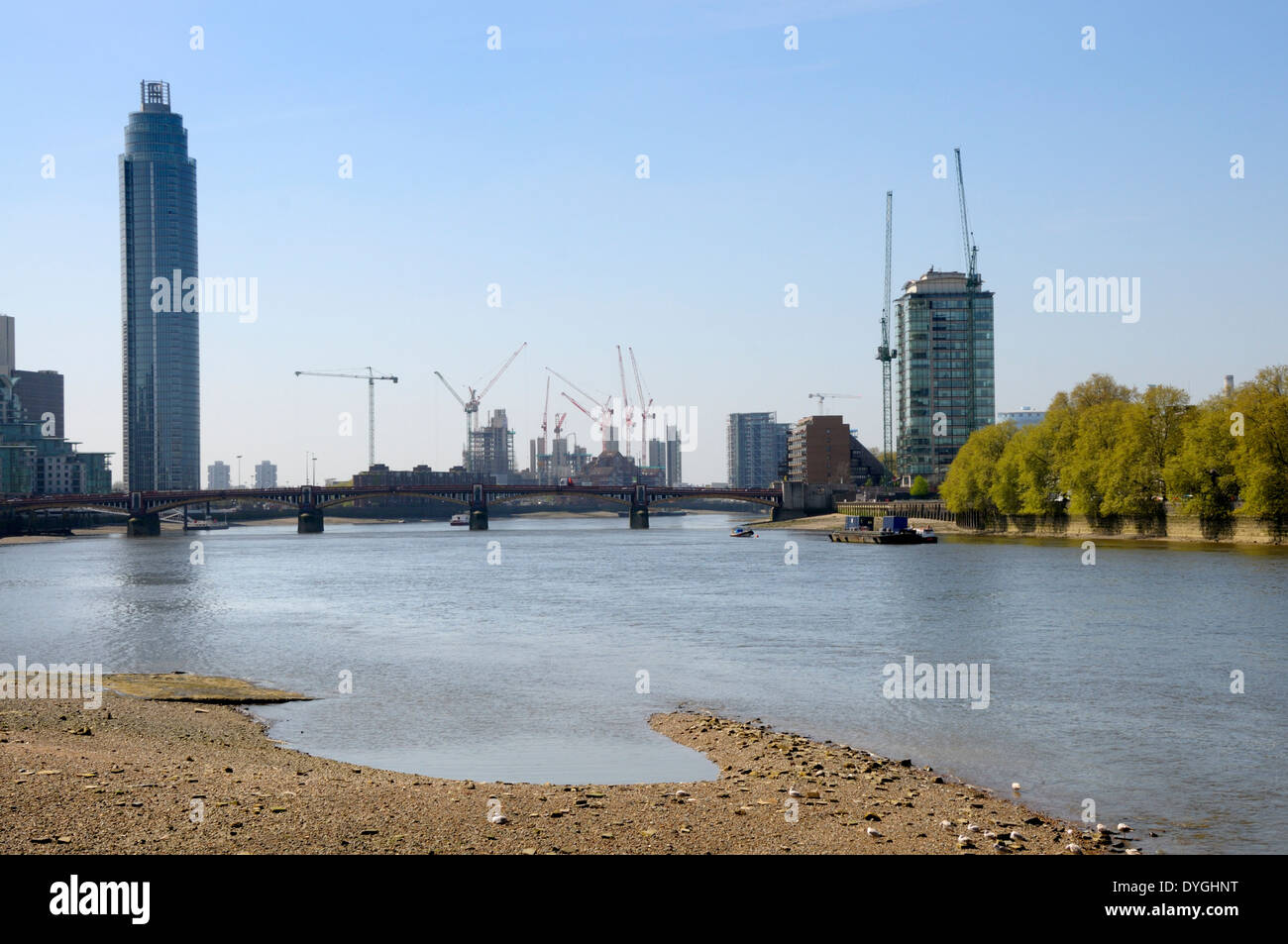 London, England, UK. St George Wharf Tower / Vauxhall Tower and cranes in South London. River Thames at low tide Stock Photo