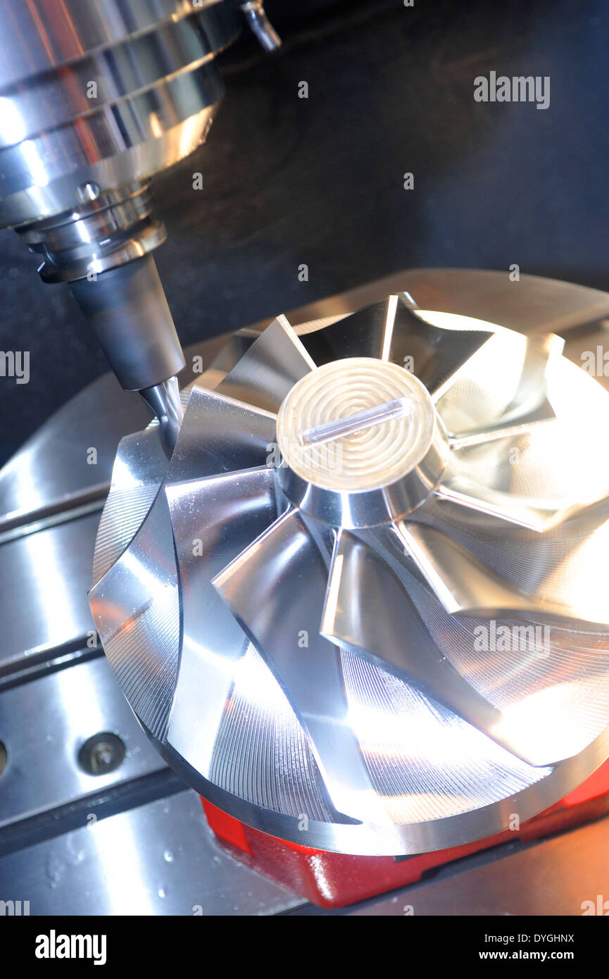 A multi axis cutting machine, cutting an impeller from a single block of aluminum. Stock Photo