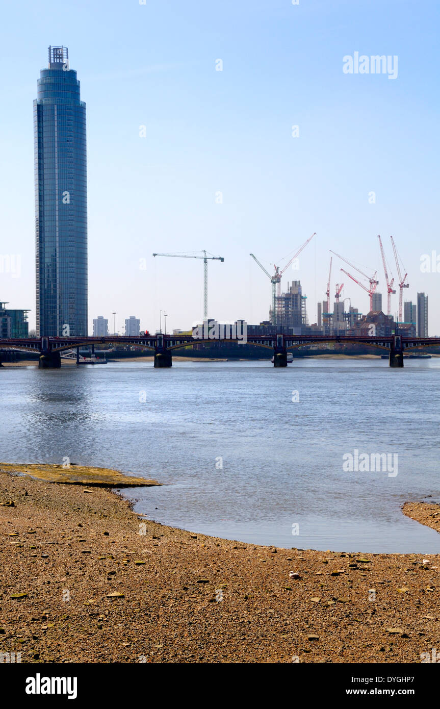 London, England, UK. St George Wharf Tower / Vauxhall Tower and cranes in South London. River Thames at low tide Stock Photo