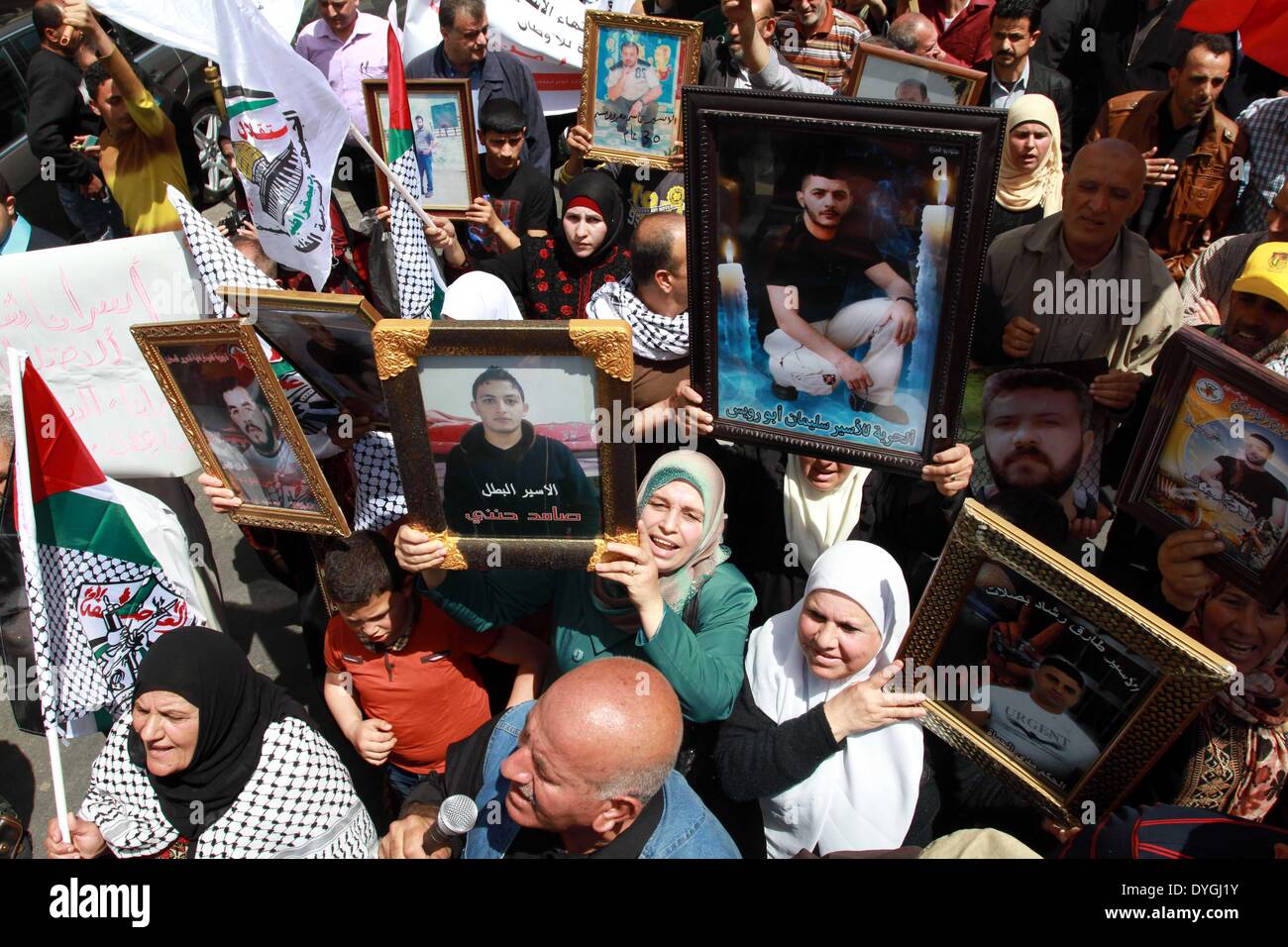 Nablus, West Bank town of Tulkarem. 17th Apr, 2014. Palestinians hold pictures of their relatives in Israeli jails as they take part in the commemoration marking Palestinian Prisoner Day, which is a solidarity day with Palestinians in Israeli jails, in the West Bank town of Tulkarem, on April 17, 2014. Credit:  Ayman Nobani/Xinhua/Alamy Live News Stock Photo