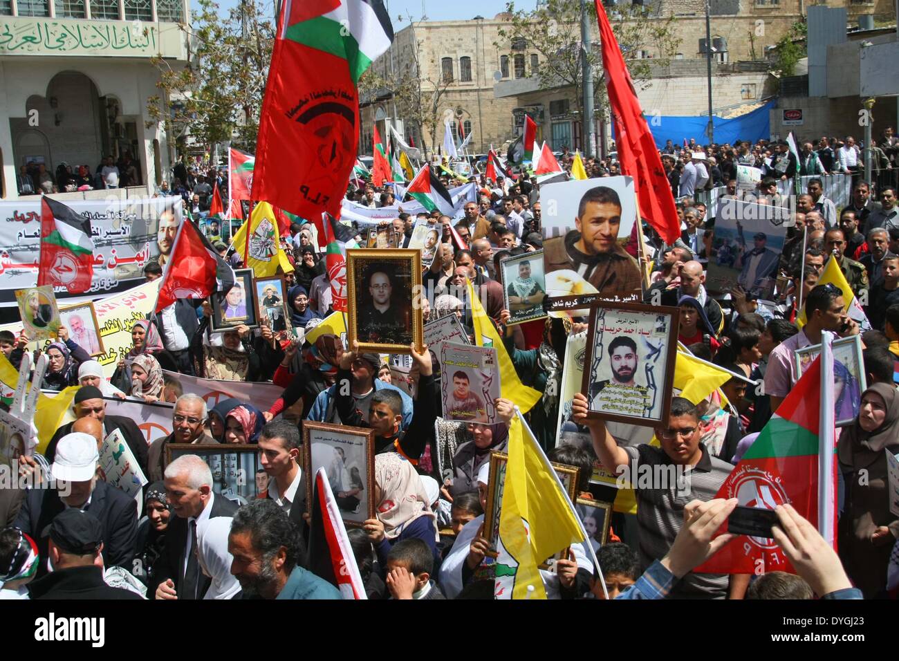 Hebron, West Bank town of Tulkarem. 17th Apr, 2014. Palestinians hold pictures of their relatives in Israeli jails as they take part in the commemoration marking Palestinian Prisoner Day, which is a solidarity day with Palestinians in Israeli jails, in the West Bank town of Tulkarem, on April 17, 2014. Credit:  Mamoun Wazwaz/Xinhua/Alamy Live News Stock Photo