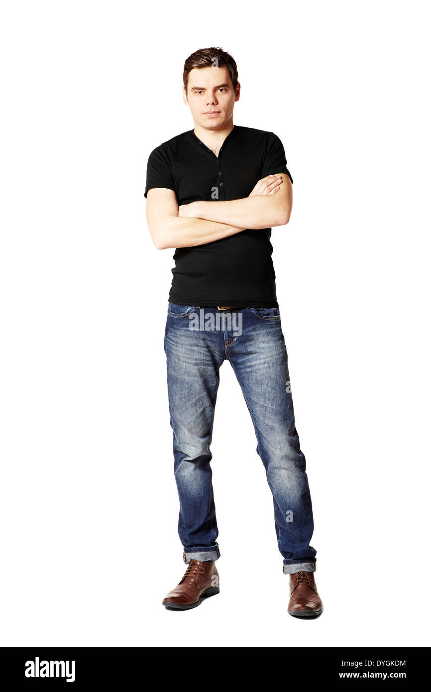 Studio shot of young man in black t-shirt and blue jeans. Stock Photo