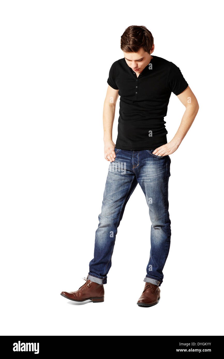 Young man watching his shoes. Studio shot. Stock Photo