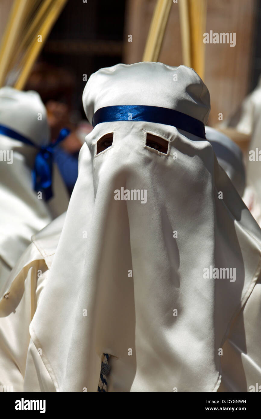 Closeup of a man, dressed in a white robe and hood on Palm Sunday