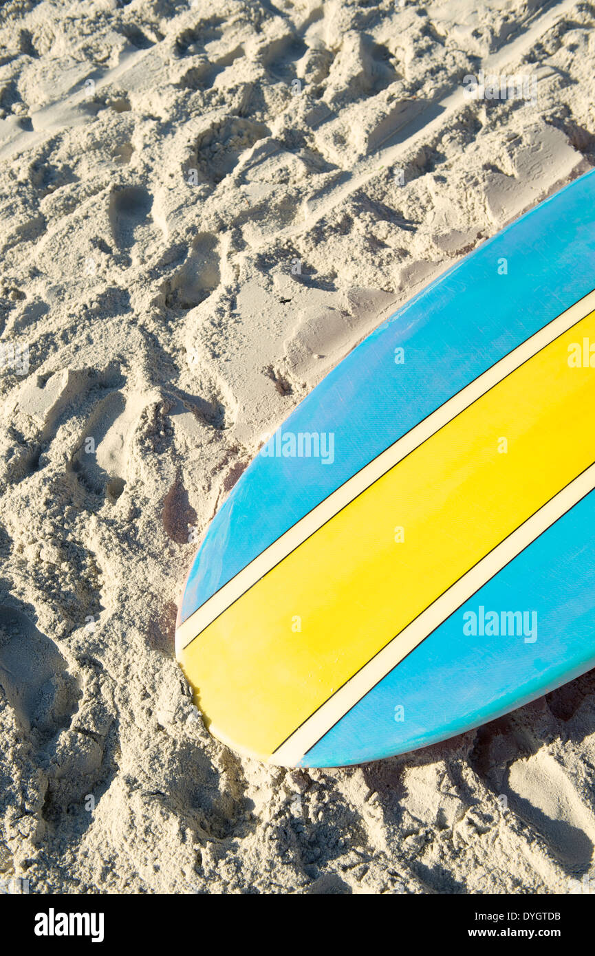 Stand up paddle long board surfboard in bright blue and yellow on Copacabana Beach Rio de Janeiro Stock Photo