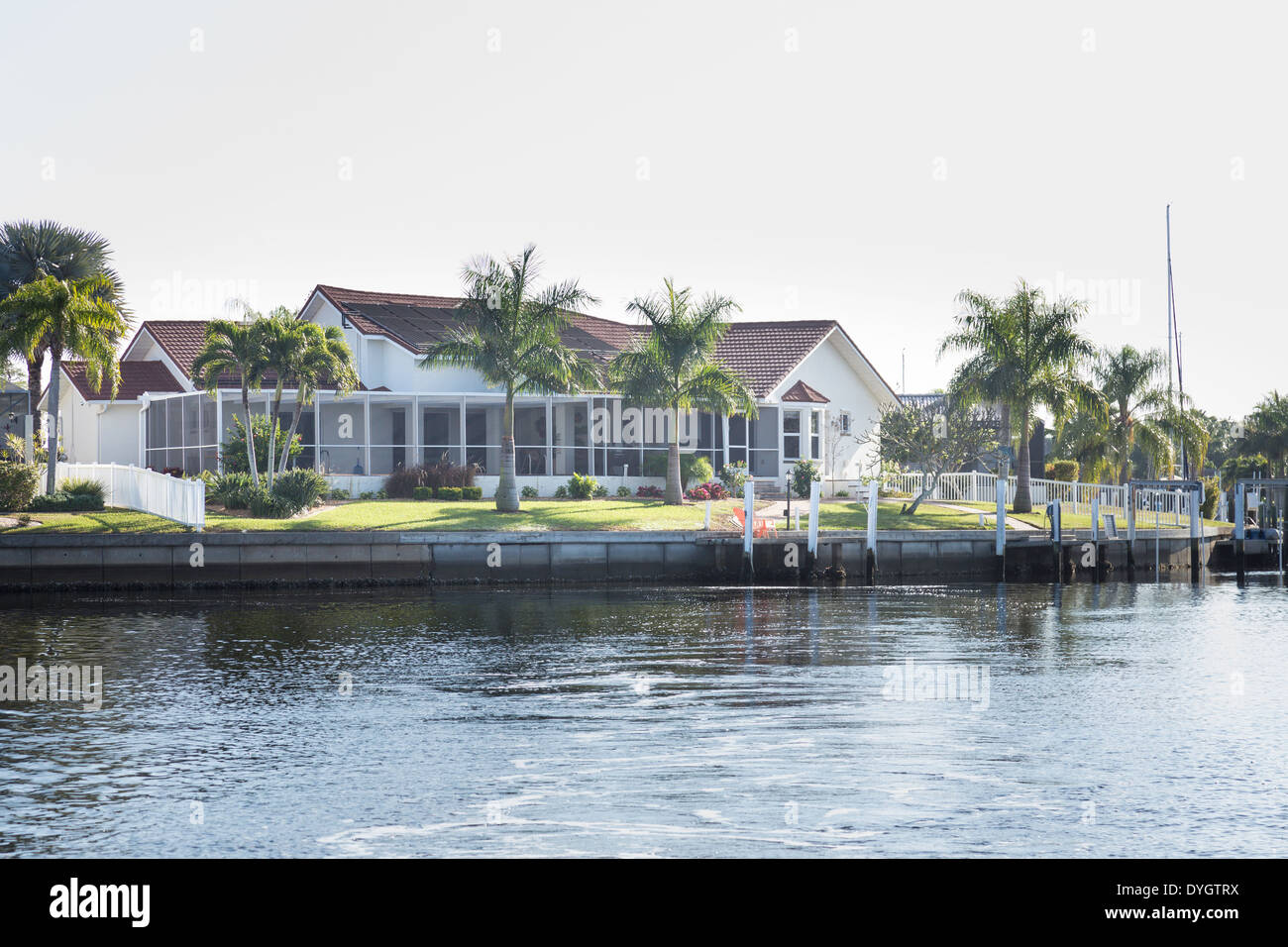 Luxury Residential Canal Front Home with Screened in Pool Deck and