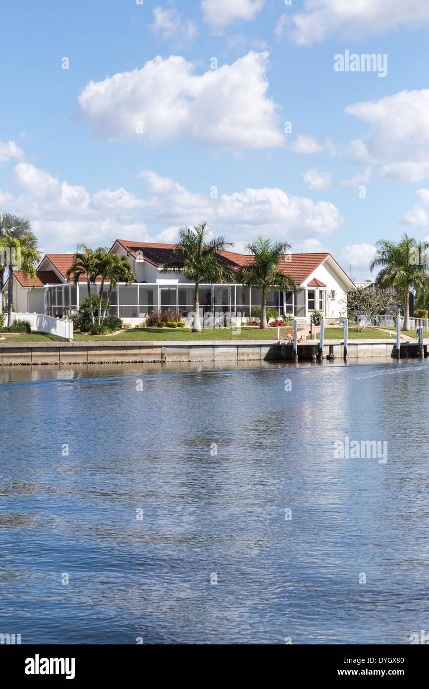 Luxury Residential Canal Front Home with Screened in Pool Deck and