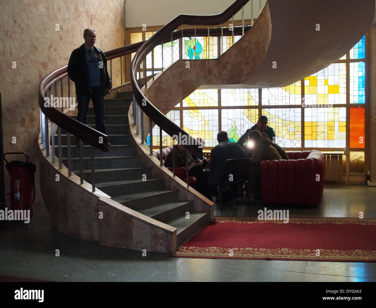 Three alleged OSCE diplomats (L) in the 'Lugan' hotel lobby discuss submissions from pro-Russian supporters who have seized the Ukrainian regional office of the Security Service in Lugansk. Stock Photo