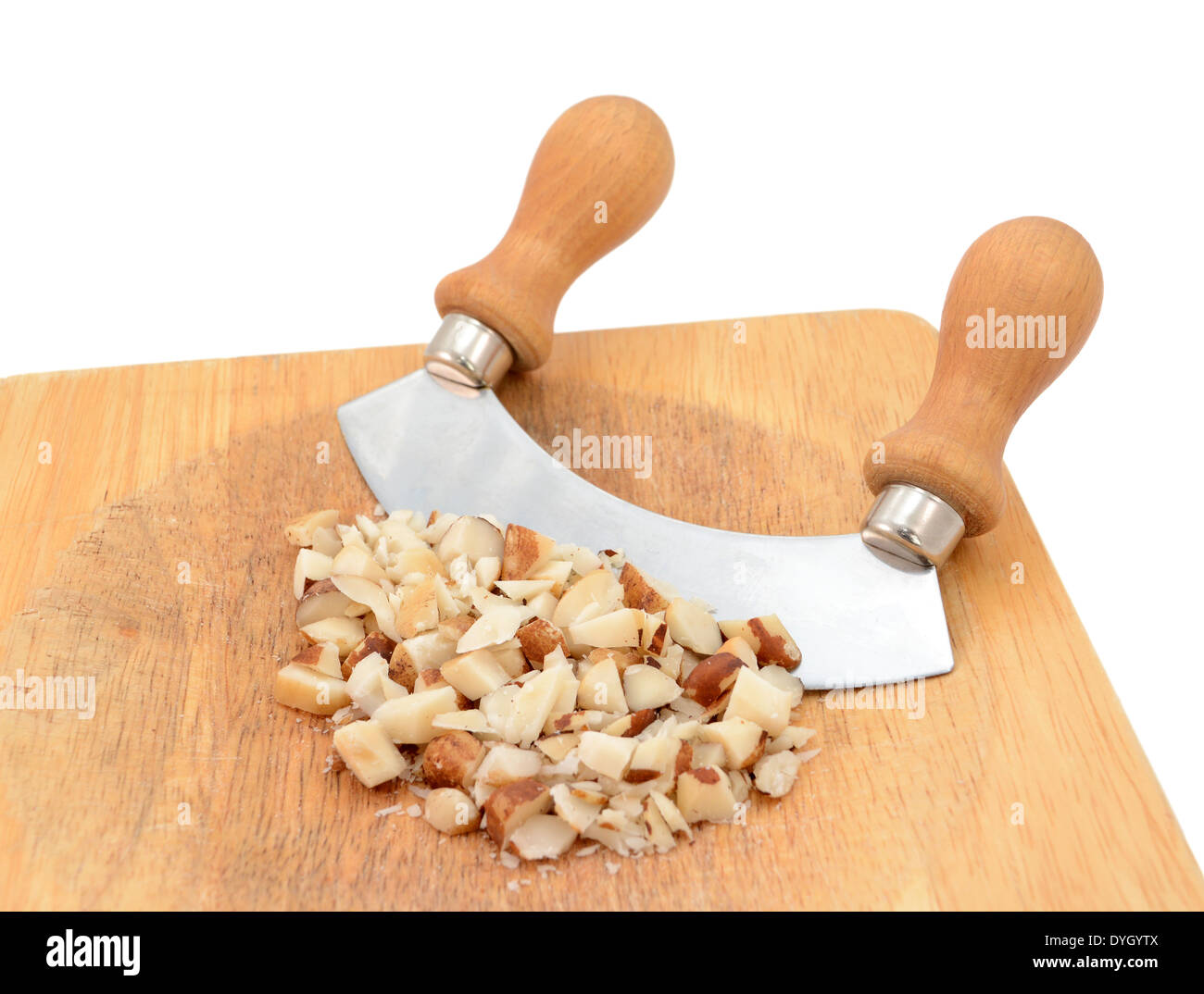 Chopped brazil nuts with a rocking knife on a wooden chopping board