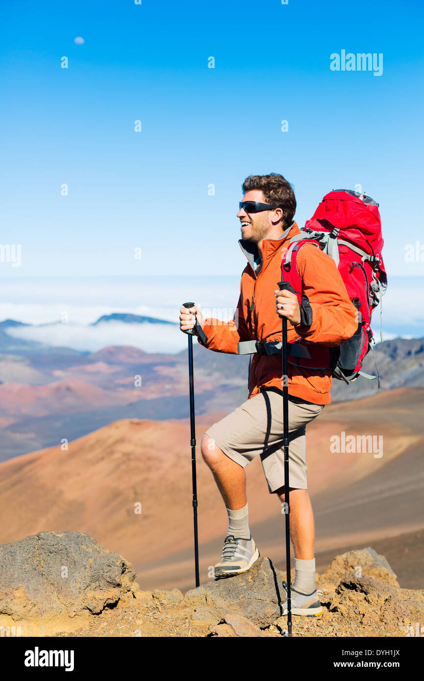 Hiker with backpack standing on mountain top enjoying the view Stock ...