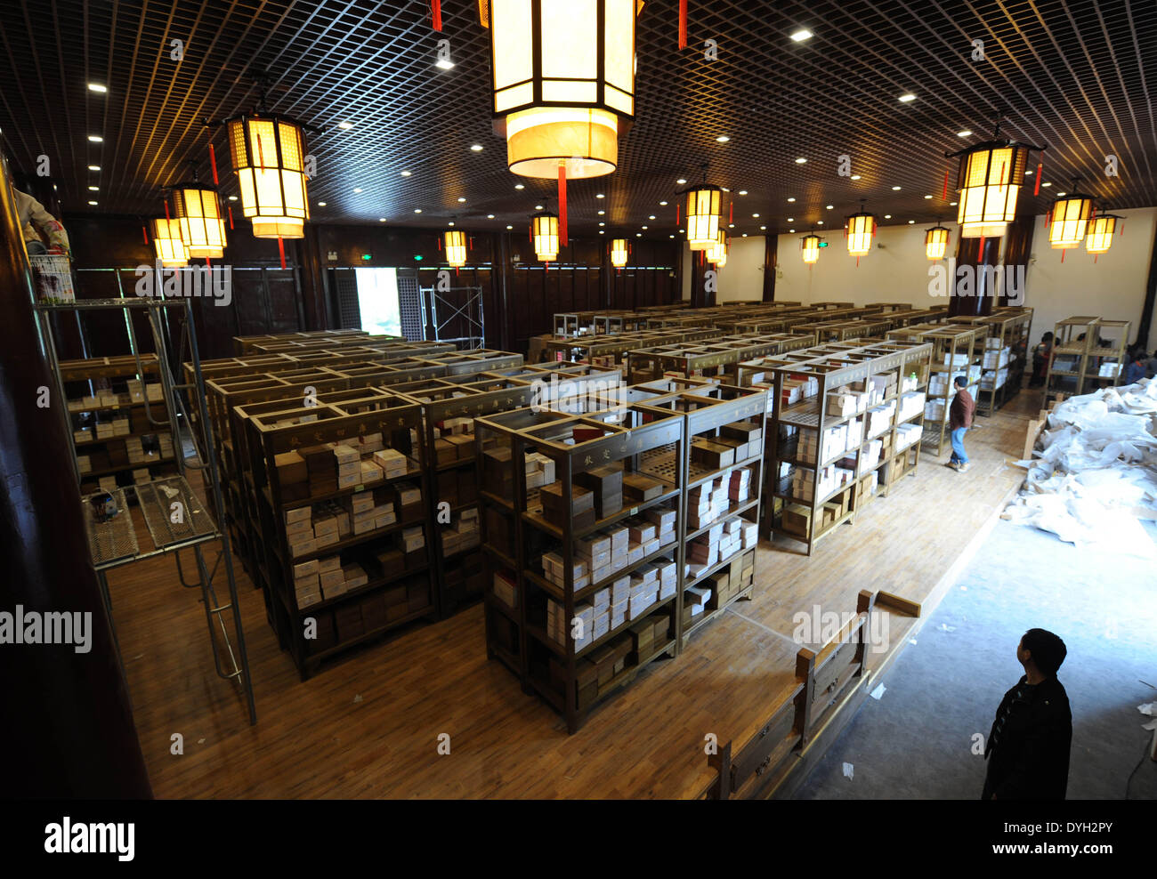 (140418) -- YANGZHOU, April 18, 2014 (Xinhua) -- Workers settle the duplicate of a classic Chinese book, the 'Siku Quanshu,' or the 'Complete Library in the Four Branches of Literature,' in the Wanfo Building at Tianning Temple of Yangzhou, east China's Jiangsu Province, April 16, 2014. The reproduction will be open to the public free of charge starting from April 18. Compilation of the 'Siku Quanshu,' launched under the reign of Emperor Qianlong (1736-1795) in the Qing Dynasty (1644-1911) and organized by the literary emperor himself, took 15 years to complete. The Yangzhou copy of the master Stock Photo
