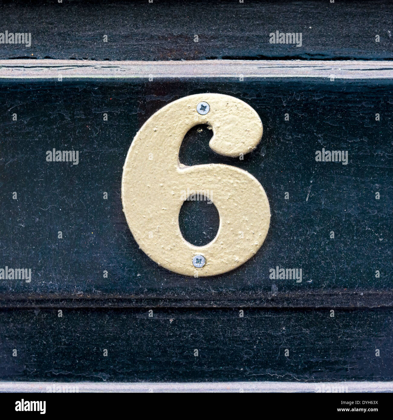house number six. White lettering against a dark background. Stock Photo