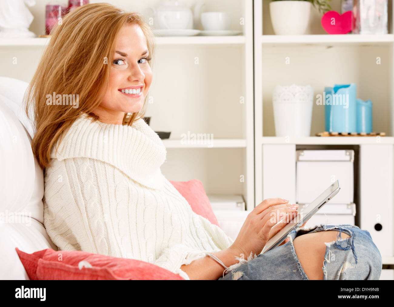 woman sitting and holding tablet Stock Photo - Alamy