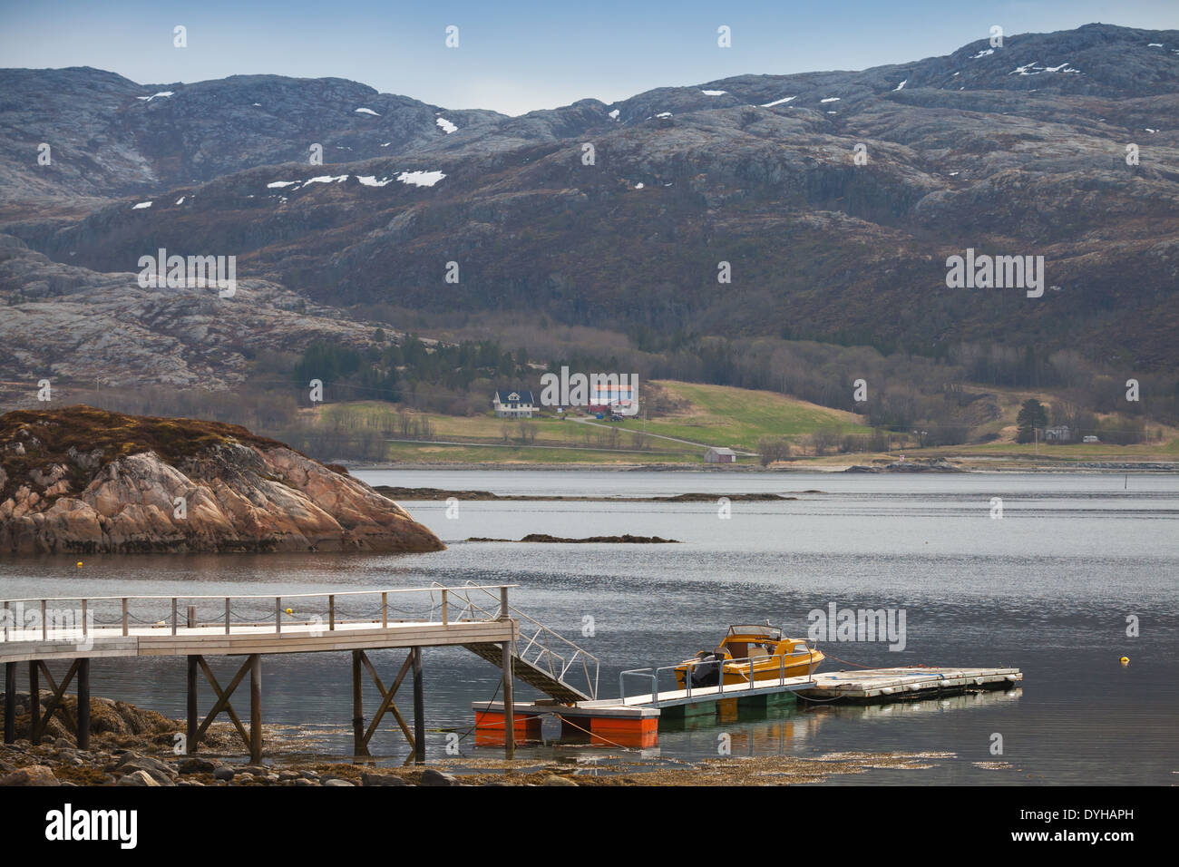 Norwegian landscape. Small motor boat stands moored near floating pier Stock Photo