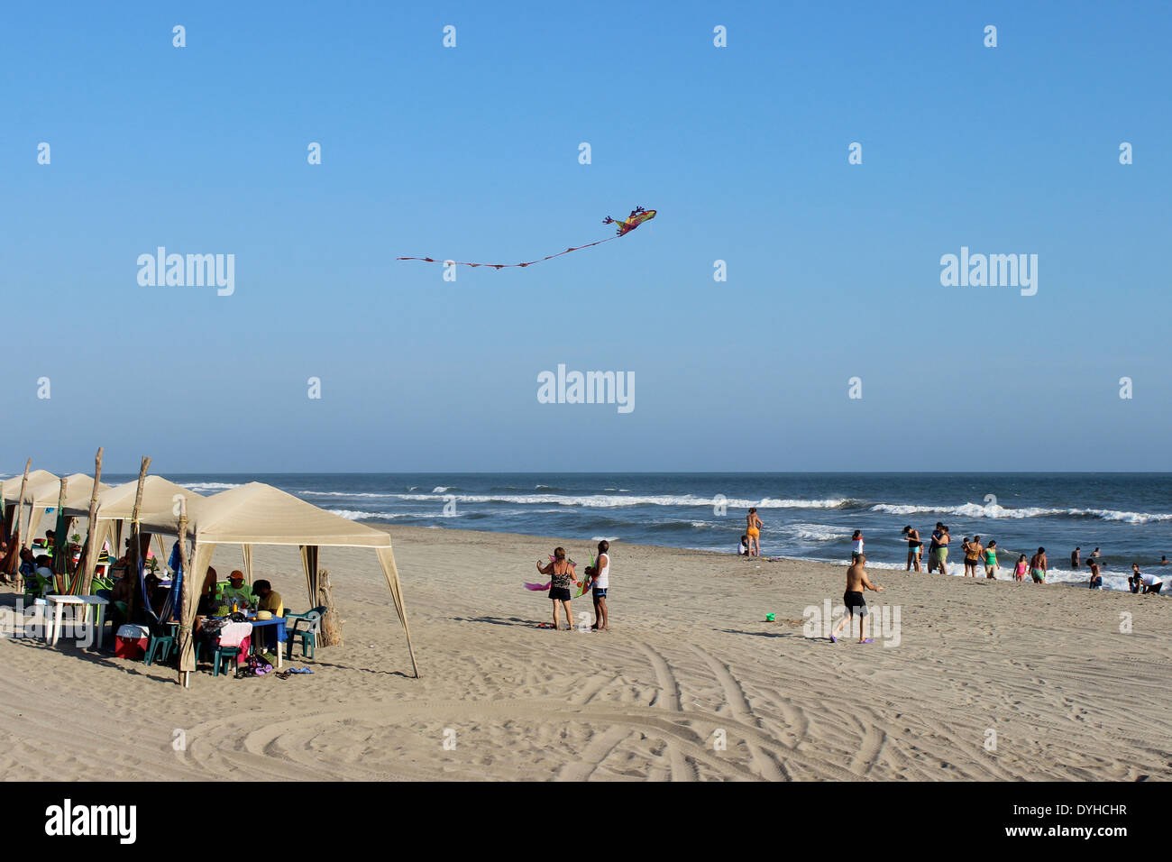 People on the beach flying a kite at Barra Vieja, Acapulco, Mexico Stock Photo