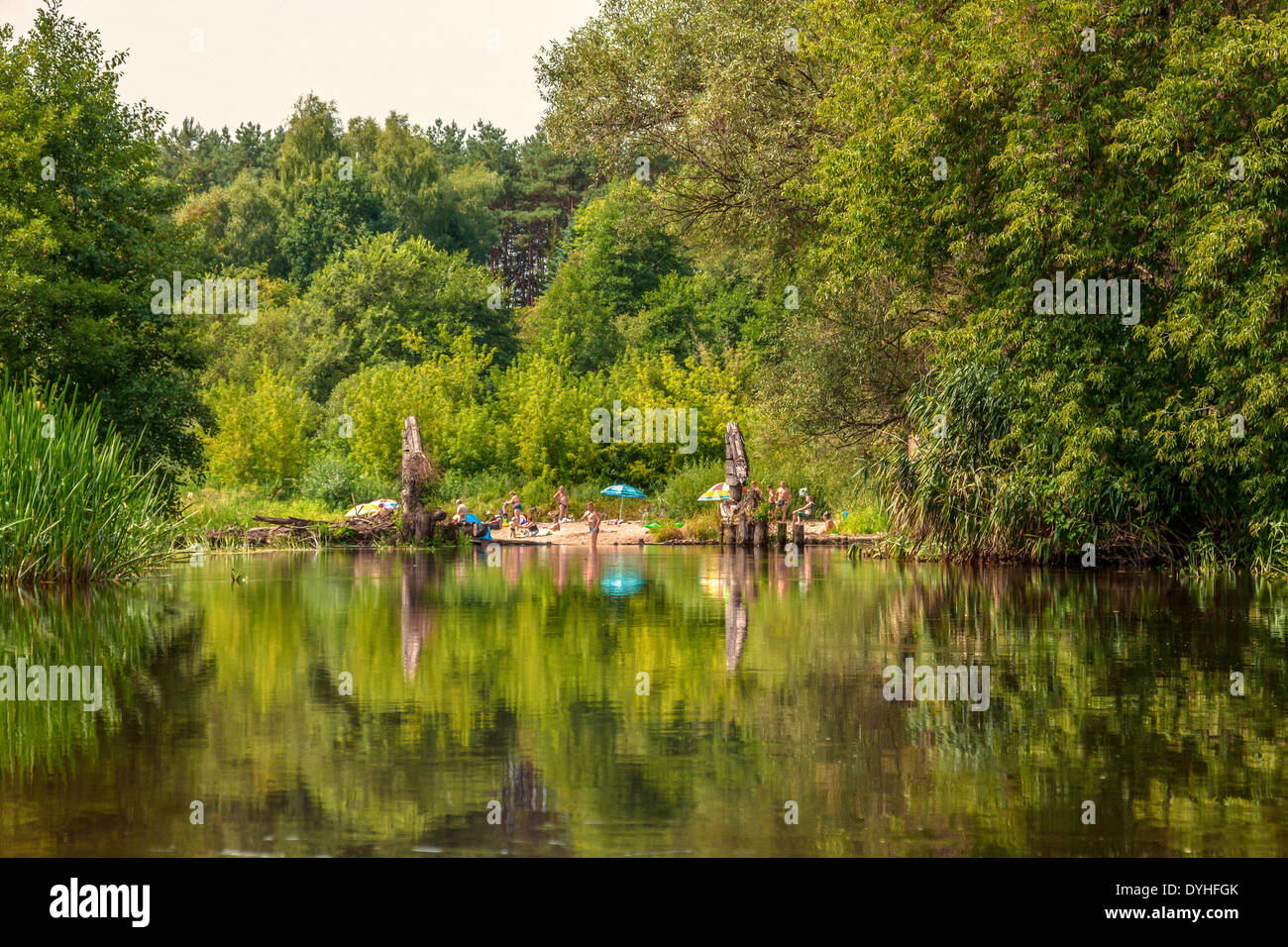 People resting on Wkra river beach, Poland Stock Photo
