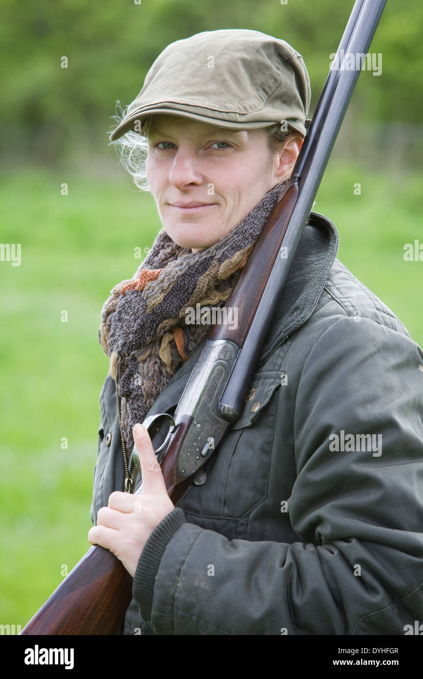 A woman wearing shooting clothing and standing outside in the English