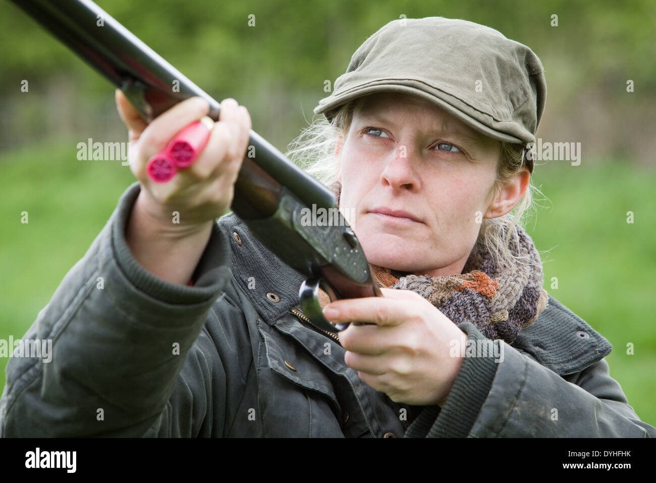 A woman wearing shooting clothing and standing outside in the English